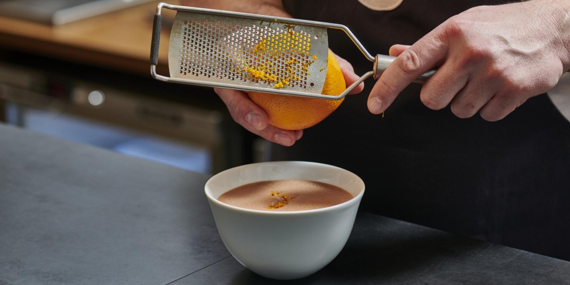 zesting orange into hot chocolate