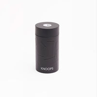 A black cylindrical tin with the brand name 'KNOOPS' written on it.
